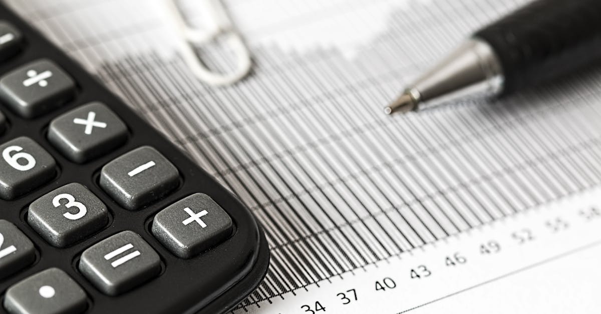 Calculator and Pen on Table · Free Stock Photo - Calculation Of Break Even Point