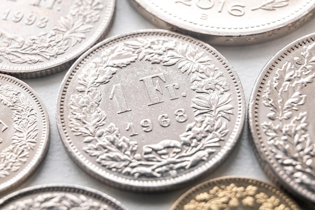Premium Photo | Swiss franc coins on white surface value of the swiss - Hoeveel Euro 1 Zwitserse Frank